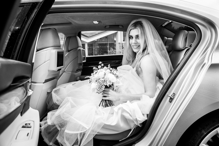 wedding shot of car and bride